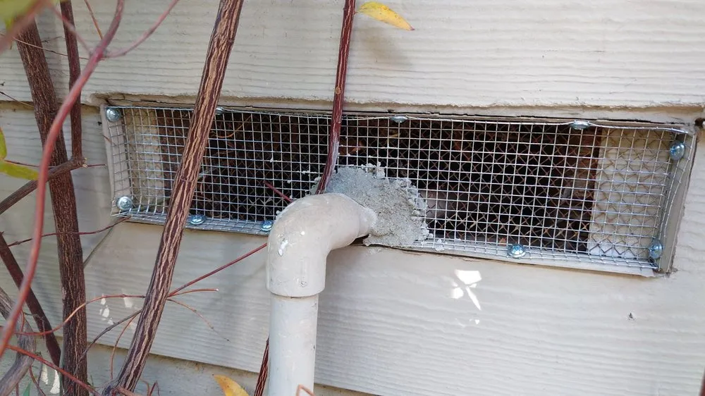 Rodent-resistant metal mesh fitted over an exterior wall vent